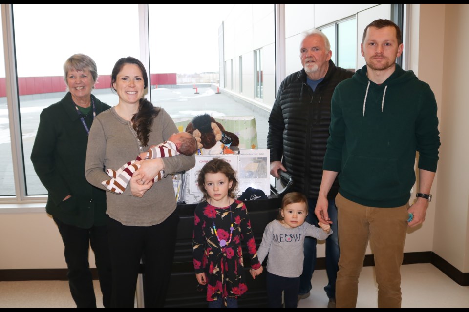Gifts are dropped off at the Dr. F.H. Wigmore Hospital for the 2020 Moose Jaw New Year’s Baby. From left to right are Beverley Morrell from Welcome Wagon, mother Courtney Thorton and baby Margaret Grace, daughters Emily and Cait Thorton, Rob Clark from Moose Jaw & District Chamber of Commerce and father Thomas Thorton. Photo by Shawn Slaght