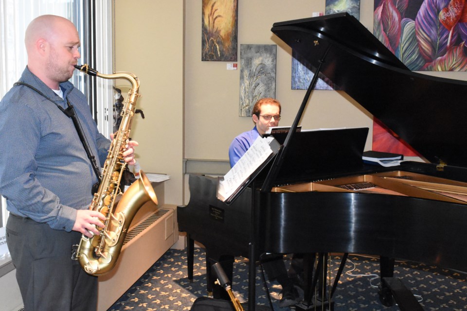 Cam Church (left) and Josh Carley perform some tunes before the start of Heartland Hospice’s inaugural fundraiser at the Mae Wilson Theatre. 