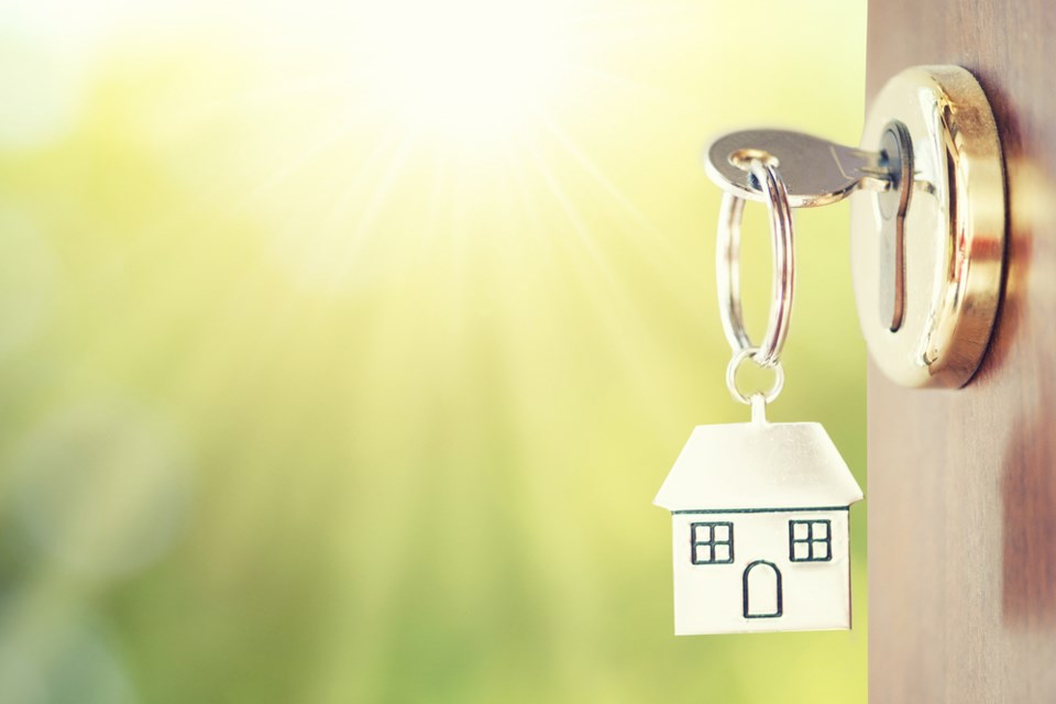 House key in door (Shutterstock)