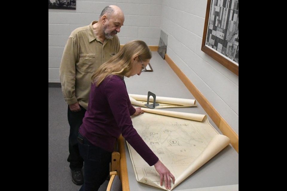 Moose Jaw public library research technician Stephanie Jeanes shows Ken Dormer one of the many blueprints on hand in the archives.