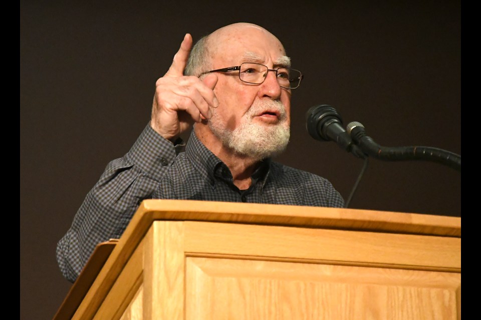 Moose Jaw’s Robert Currie reads from his new book 'Shimmers of Light'  during the book launch at the Moose Jaw Public Library theatre on Wednesday night.