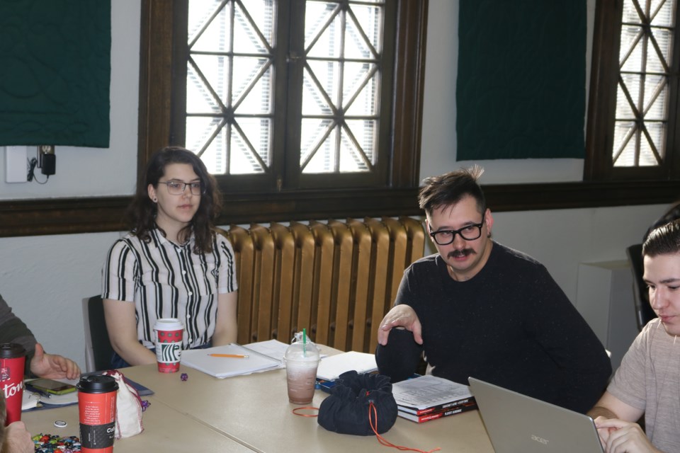 Brynn Clothier and Jason Williamson play a round of Dungeons and Dragons at the Moose Jaw Public Library on Saturday. Photo by Shawn Slaght