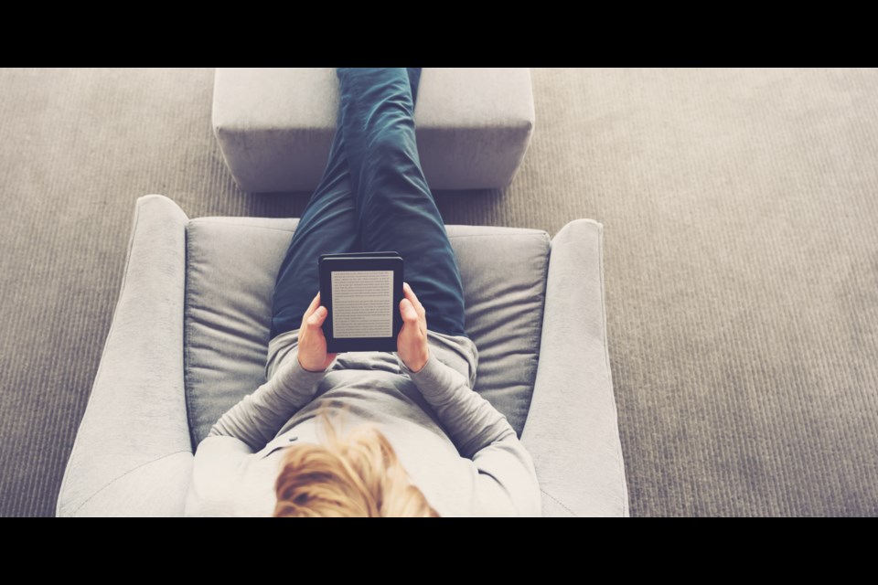 A person reading an eBook. (Shutterstock photo)