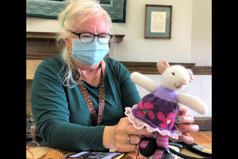 Monica Trautmann shows off a knitted mouse she created during the pandemic. Photo by Jason G. Antonio 