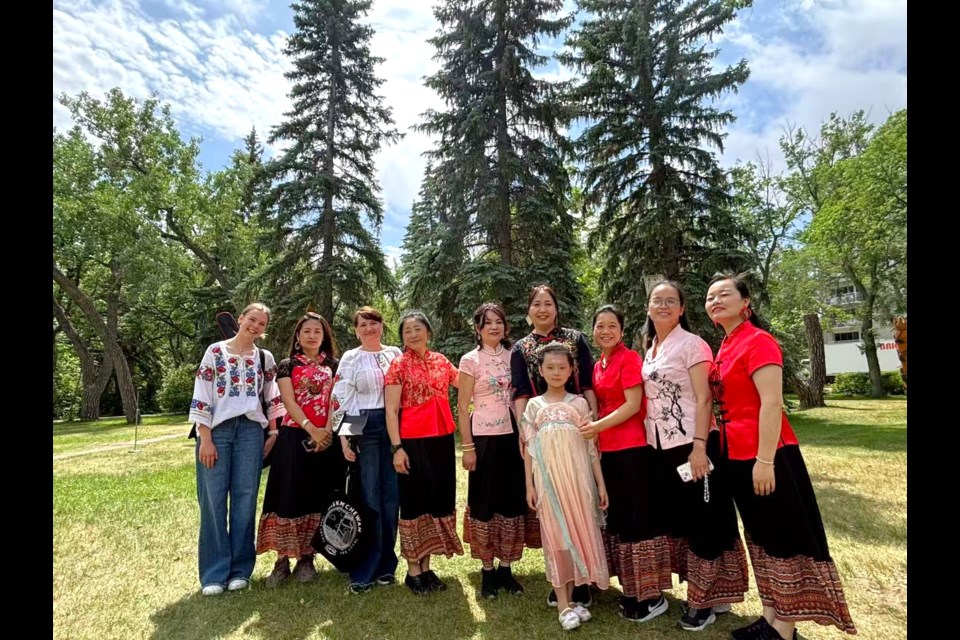 Chinese dancers break for a photo following their performance that opened the library's Summer Reading Club this month.