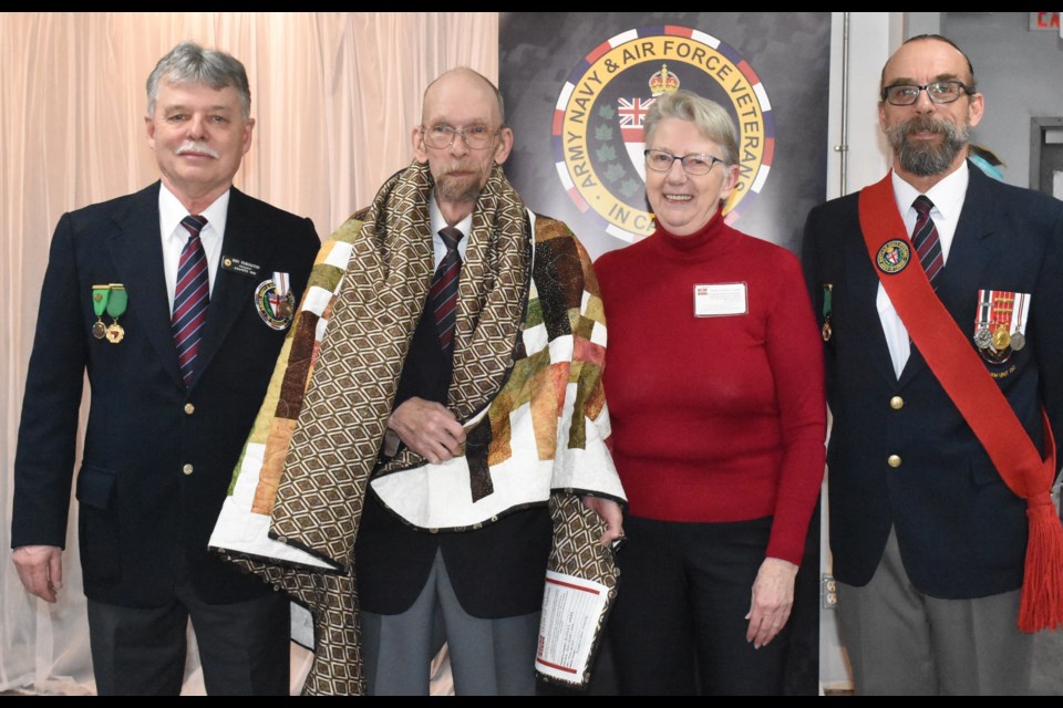 Ed Webb (second from left) receives a Quilt of Valour from Beth Andrews (second from right), the Saskatchewan rep for the national program, during a ceremony at the ANAVETS Club 252 venue. Also pictured are club president Don Purington (left) and sergeant-at-arms Ron Roy (right). Photo by Jason G. Antonio