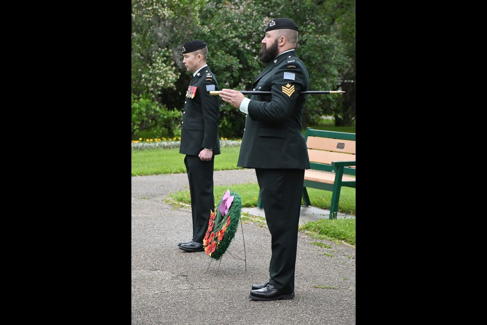 Sgt. Steven Arens (front) and Maj. Mack Driscoll, commanding officer of the Saskatchewan Dragoons, pause before laying their Decoration Day wreath.