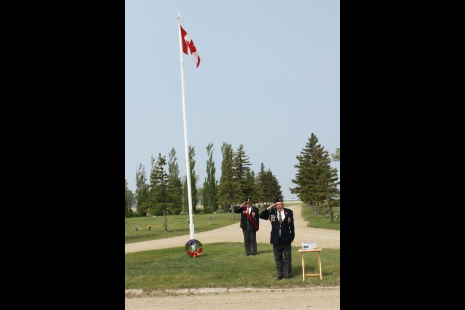 Legion members and friends visited city cemeteries on Sunday, June 2 to place miniature Canadian flags on the graves of local veterans. Services were held at Sunset and Rosedale Cemeteries, followed by an afternoon service at the cenotaph in Crescent Park. Steve Richardson and Dan MacAulay salute during the playing of O Canada at Sunset Cemetery. Photo boy Joyce Walter