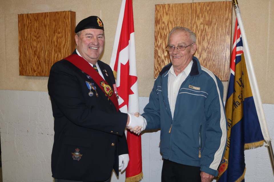 Keith Acott, right, receives his 55-year service pin from Sergeant-at-Arms Steve Richardson at the Royal Canadian Legion Moose Jaw Branch No. 59 on Saturday. Photo by Shawn Slaght