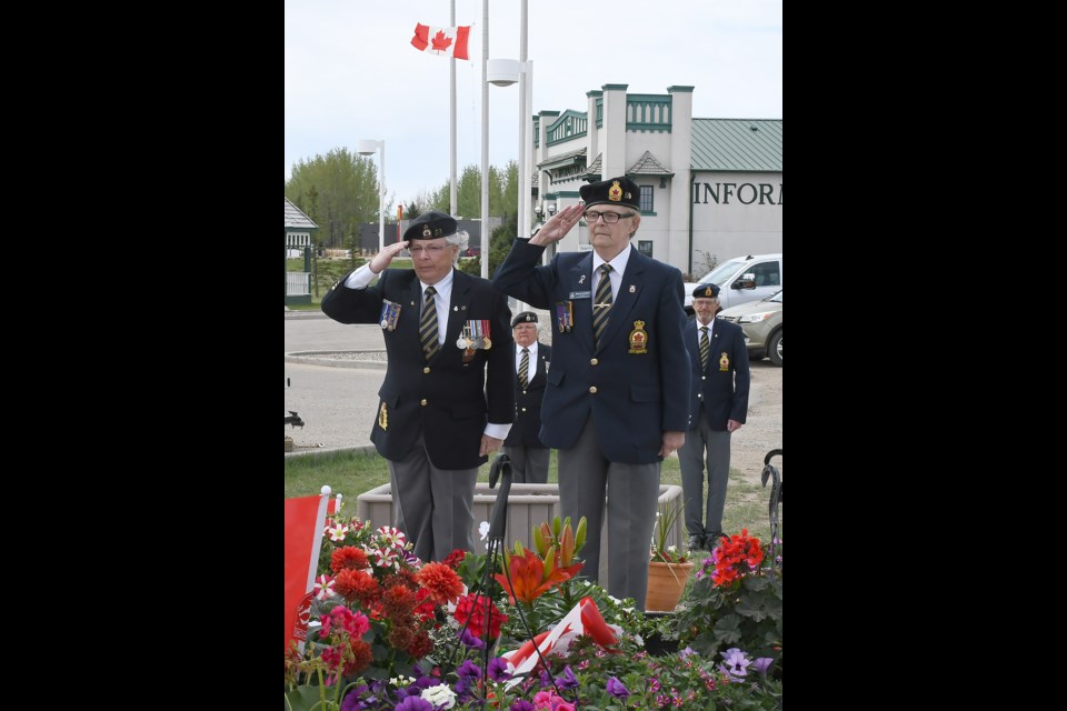 Royal Canadian Legion Branch 59 Moose Jaw vice president Sue Knox and president Sharon Erickson salute after laying a wreath at memorial set up at the base of the Tourism Moose Jaw Snowbirds jet.