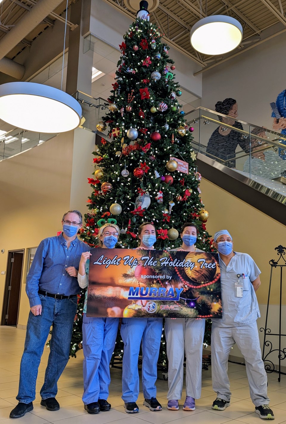 kelly-mcelree-stands-with-healthcare-staff-at-the-hospital-after-lighting-up-the-giant-tree-l-r-mcelree