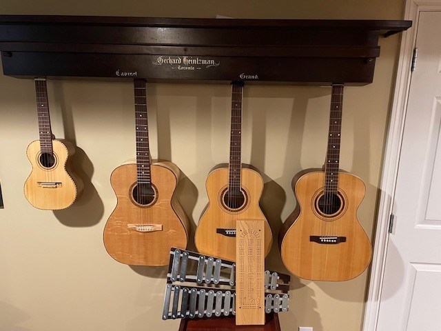 A ukulele, three guitars, a wooden xylophone, and a cribbage board hang from the top portion of a repurposed piano at Bill Lawson’s home in Tugaske, Sask.