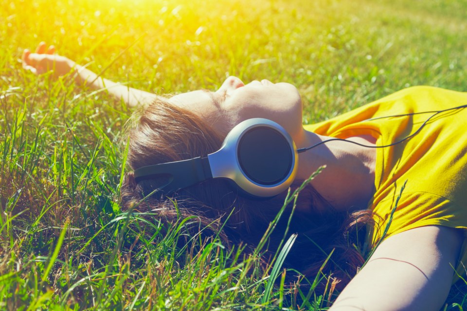 listening to music in the grass shutterstock