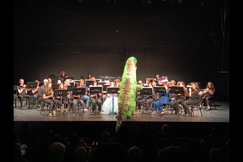 Vanier’s year-end band concert was ‘dino-mite,’ as band and choir director David Selensky switched his wardrobe to a dinosaur costume to perform the “Theme from Jurassic Park”