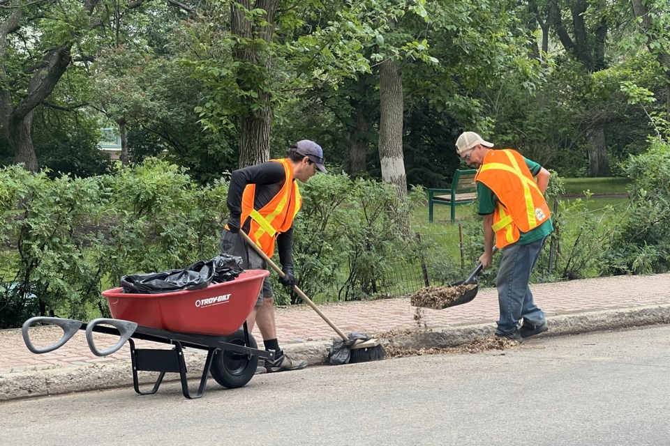 Volunteers with the Downtown Moose Jaw Association’s Helping Hands program clean up along Langdon Crescent ahead of the weekend farmers market.