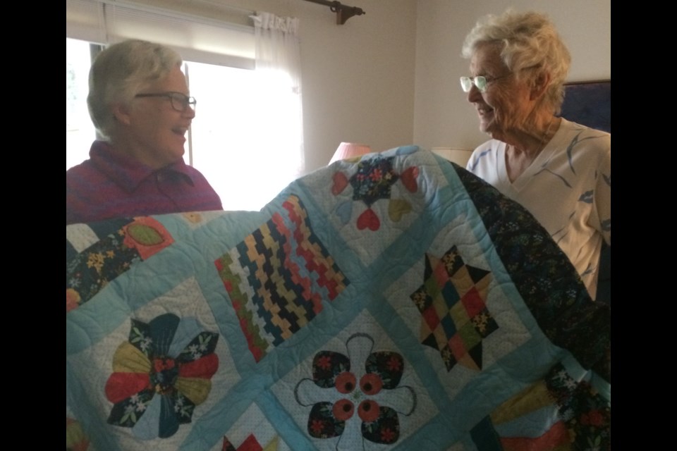 Dawn Nica Mathieson (left) presents Pat Harris (right) the Grand Prize.  Photo by Lorna Arnold.  