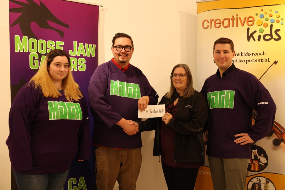 MJGA president Brooks Nancarrow (second from left) presents a $5,000 donation to Creative Kids manager Gloria Walsh (centre), along with MJGA’s vice-president Talon Regent