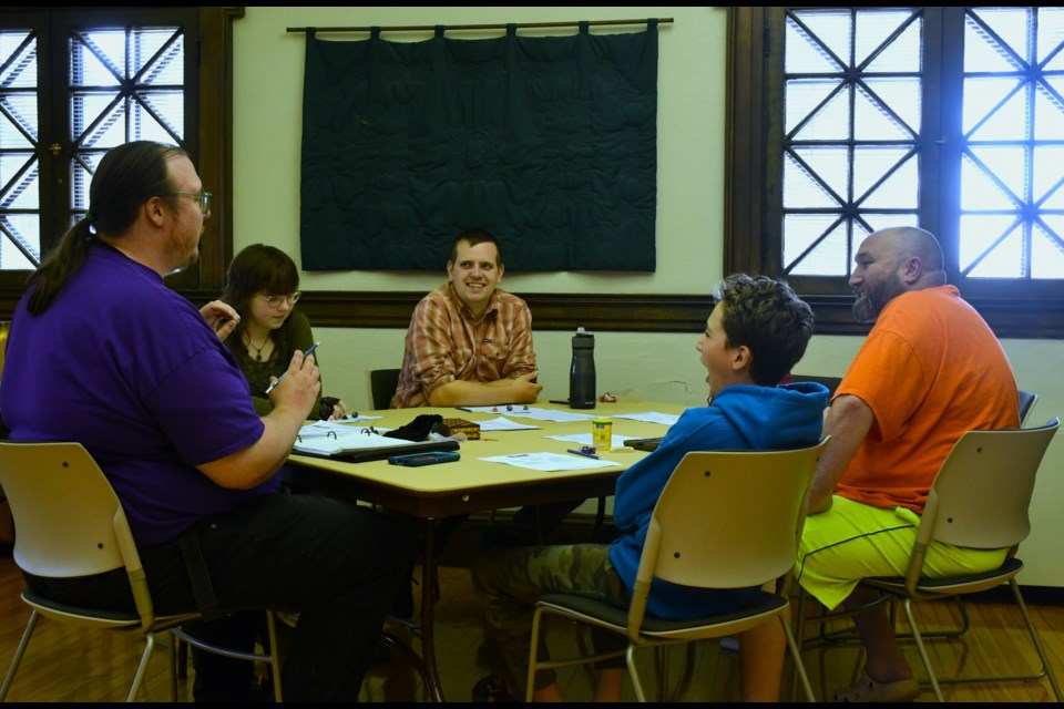 Participants gather around a table during the Moose Jaw Gamers Association’s one-day tabletop RPG event, held July 12 at the Moose Jaw Public Library.