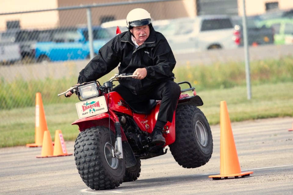 A Shriner pulls a wheelie on a three-wheel quad during practice for the Midwest Shrine Association parade in Moose Jaw Aug. 23.