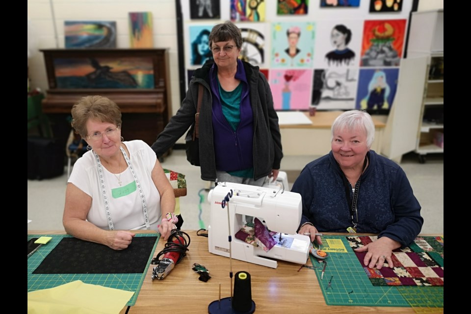 Members of the Prairie Hearts Quilter's Guild work on Christmas placemats at Vanier Collegiate on Nov. 18.