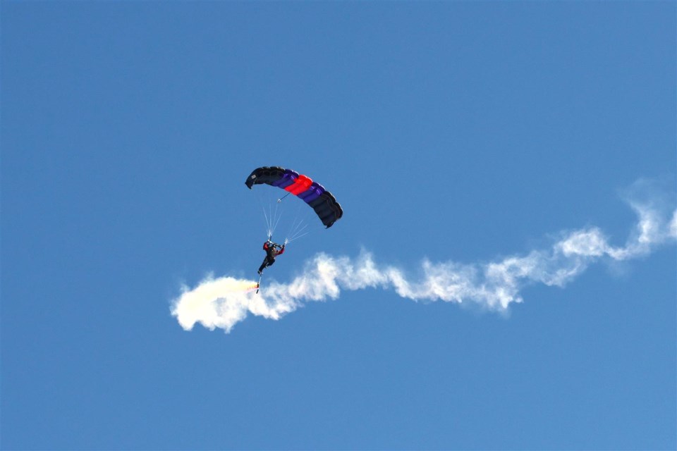 Burk Reiman of Skydive South Sask streams smoke as he glides in to Gutheridge Field
