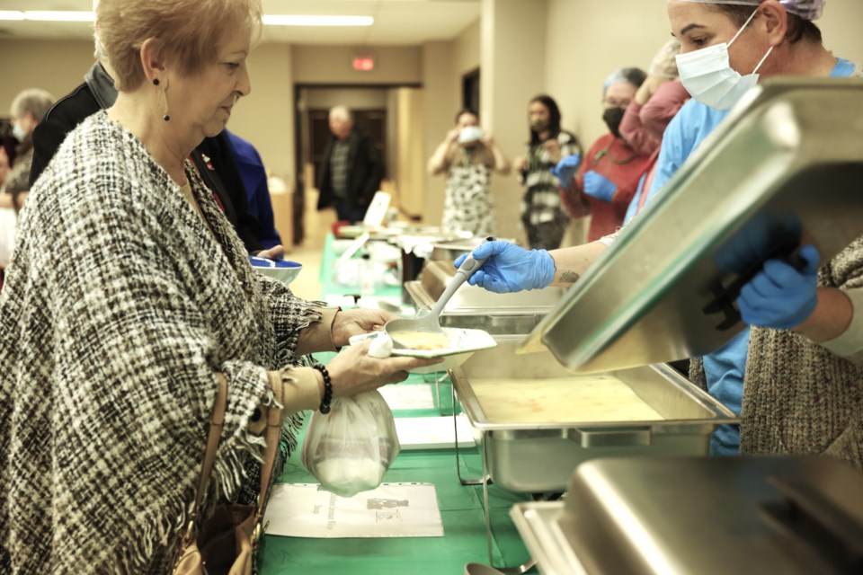 Volunteers serve soup to guests at the first annual Empty Bowls fundraiser in 2022