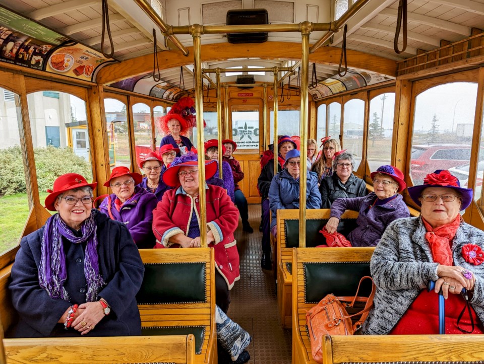 The ladies of the Red Hat Society gather on the Moose Jaw Trolley for a tour, lots of laughs, and some fabulous headwear