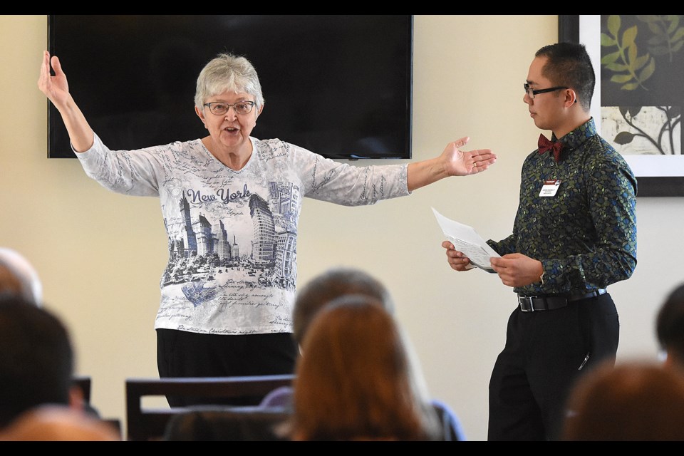 Margaret Ustupski gestures while answering a question from Toastmasters contest chair Geremy Quiambao.