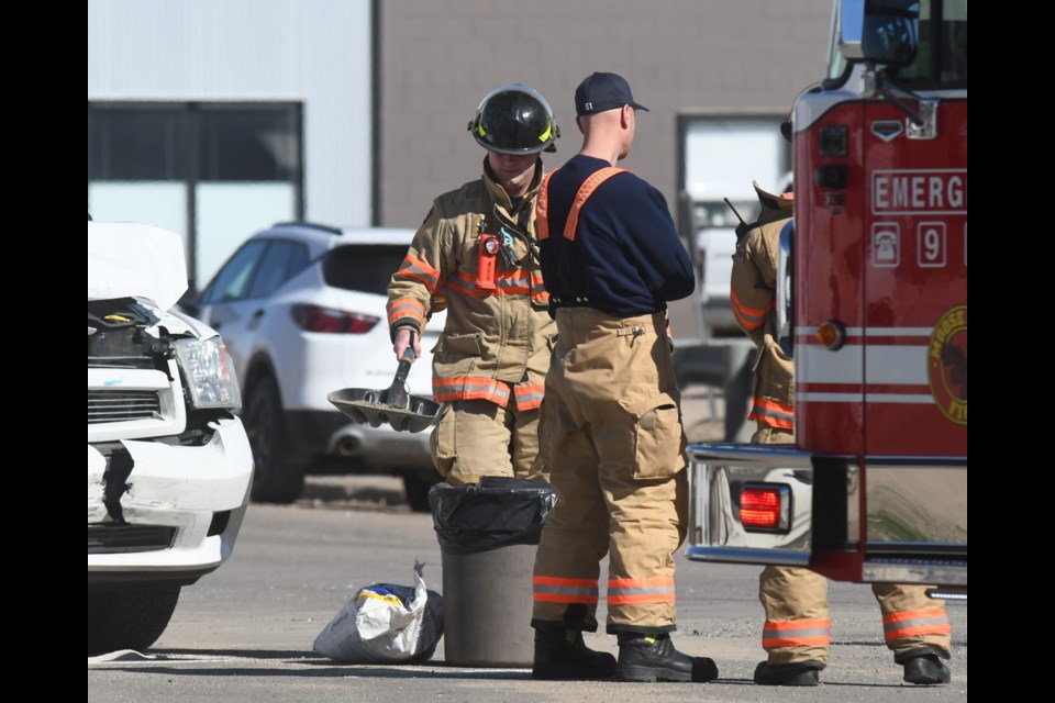 Crews work to re-open High Street West in front of SGI Claims Centre around 4 p.m. April 26.