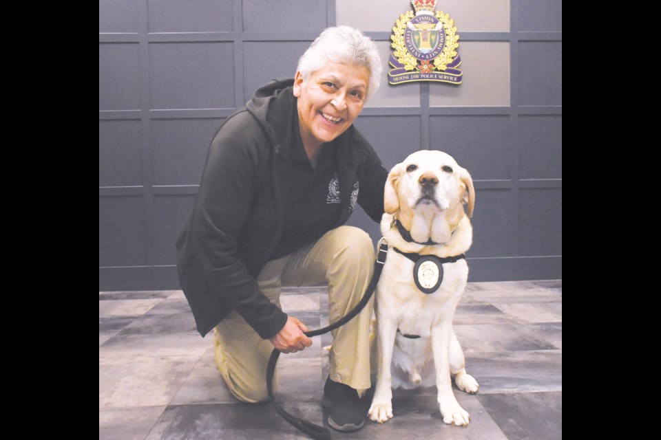 Donna Blondeau, Victim Services co-ordinator, and her canine colleague Kane, a facilities dog that provides comfort to traumatized people, pose inside the Moose Jaw Police Service building. Blondeau is retiring this July after 33 years with the force, while Kane is retiring after six years. Photo by Jason G. Antonio 