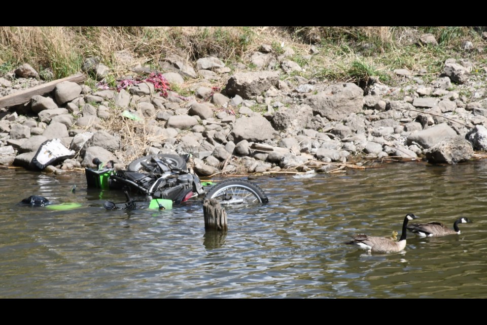 The collision left this motorbike in the Moose Jaw Creek. Photo by Jason G. Antonio 