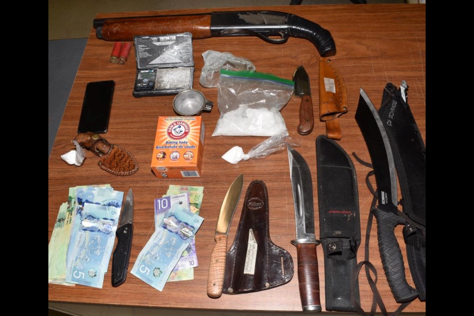The drugs, cash and weapons that police seized during a traffic stop. Photo courtesy Facebook