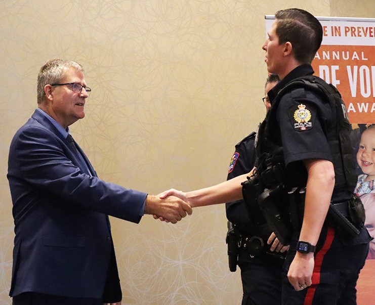 Const. Alanna Coghill (right) receives a Silver Challenge Coin for her efforts removing impaired drivers from the road. Photo courtesy Moose Jaw Police Service