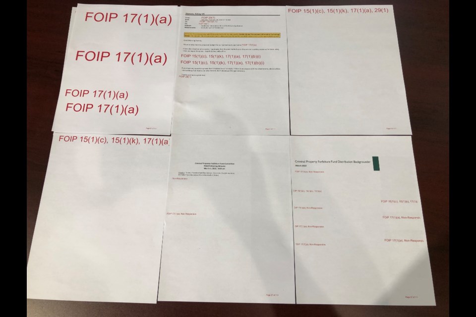These are just some of the (blank) 111 pages that the provincial government sent in relation to the police service's need for a tactical unit. Photo by Jason G. Antonio 