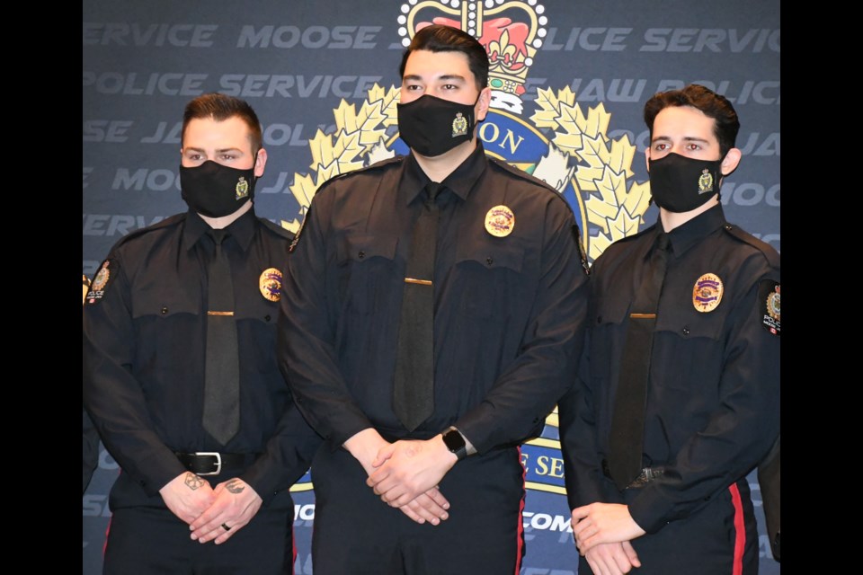 New police recruits Austin Abbott, Eric Giroux and Mason Fischer gather for a picture after the ceremony. Photo by Jason G. Antonio 