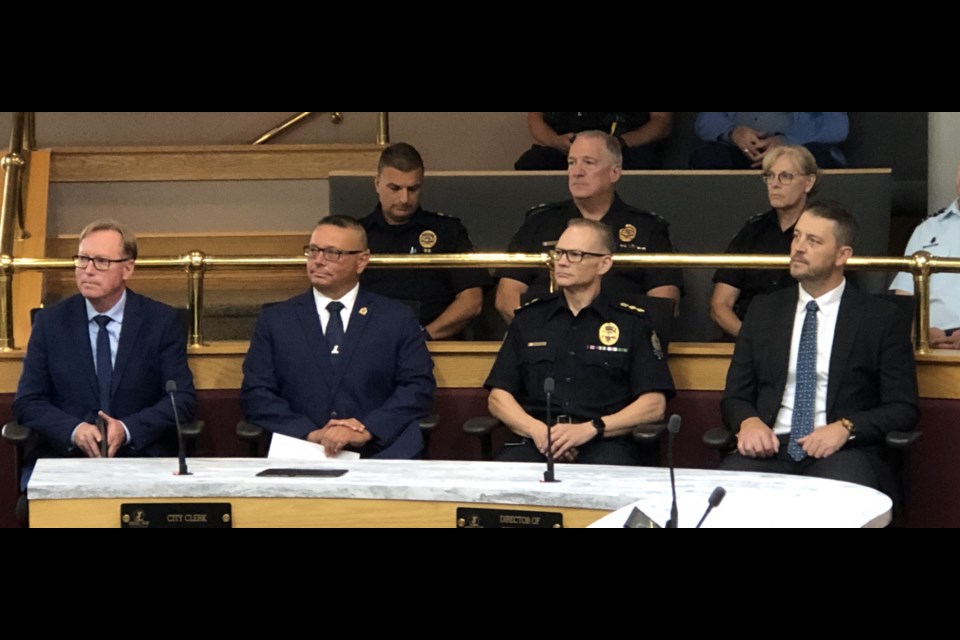 Dignitaries gather in council chambers to welcome Robert Davis as the new chief of police in Moose Jaw. In front, from left, are Mayor James Murdock, chairman of the police board; new Chief Robert Davis; Acting Chief/Deputy Chief Rick Johns; and the Hon. Tim McLeod, MLA. Photo by Jason G. Antonio