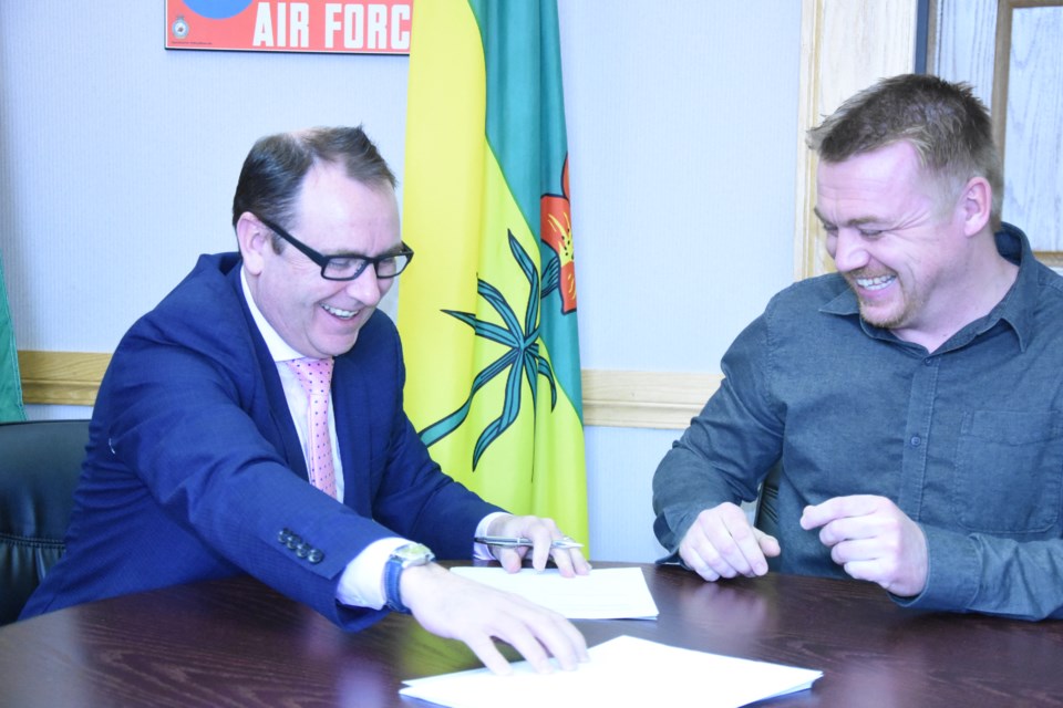 Mayor Fraser Tolmie, chair of the Moose Jaw Board of Police Commissioners, and Taylor Mickleborough, vice-president of the Moose Jaw Police Association, officially sign the new collective bargaining agreement at City Hall. The contract expires in December 2020. Photo by Jason G. Antonio