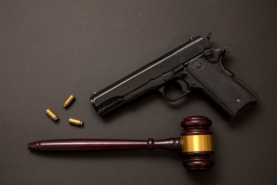 A gavel and a handgun. Under proposed federal legislation, Canadians would no longer be able to acquire new handguns (Rawf8-iStock-Getty Images Plus)