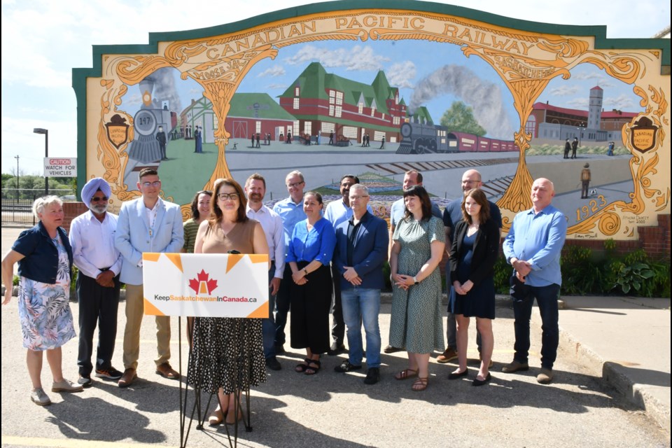 The Saskatchewan NDP gathers in front of the former Canadian Pacific Railway station for a news conference. Photo by Jason G. Antonio