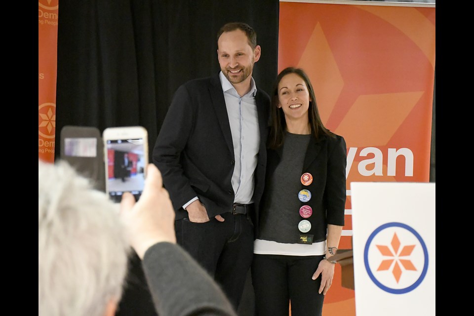 Sask NDP leader Ryan Meili pauses for photos with Moose Jaw Wakamow NDP candidate Melissa Patterson.