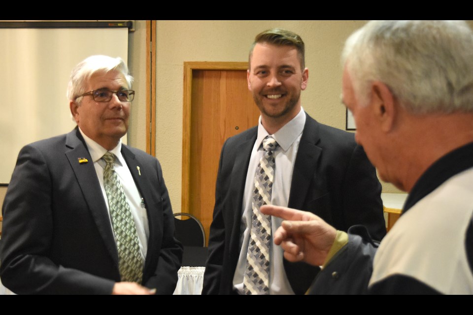 Ron Bruck chats with current Moose Jaw North MLA Warren Michelson and incoming candidate Tim McLeod during the Sask Party nomination meeting Monday.