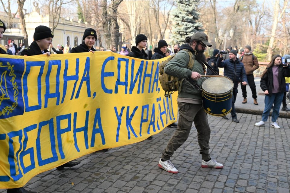 A drummer led the patriotic flag waving march down the central cobblestone streets in Odessa on Wednesday afternoon