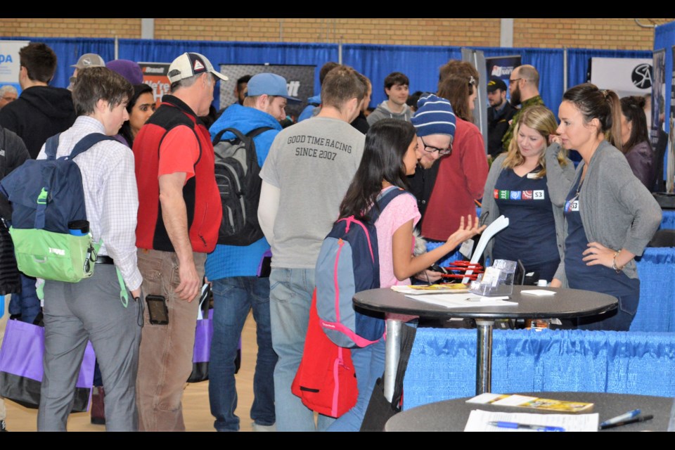 Jenna Parenteau, the office manager for S3 Enterprises, right, talks to Business Management student Neenu Paily at the Saskatchewan Polytechnic career fair Wednesday. (Matthew Gourlie photograph) 