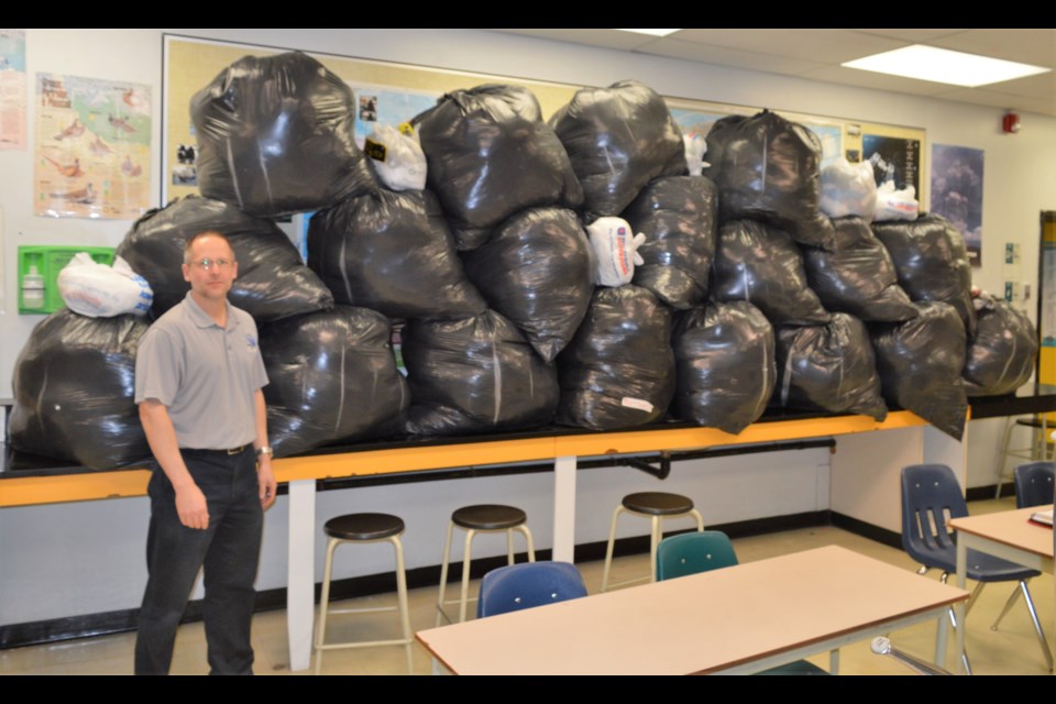 Stephen Lys stands in front of some of the plastic bags that have been collected in his Environmental Science 20 classroom at A.E. Peacock Collegiate. (Matthew Gourlie photograph)