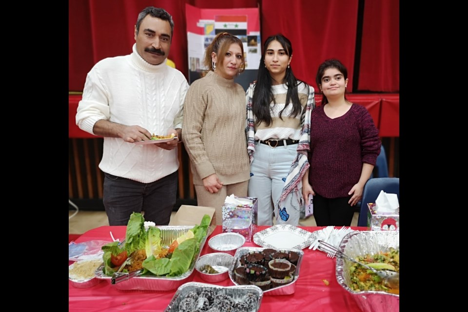 Students along with their parents represent Afghanistan with a wide range of food to sample at the Nov. 23 multicultural fair at Central Collegiate.