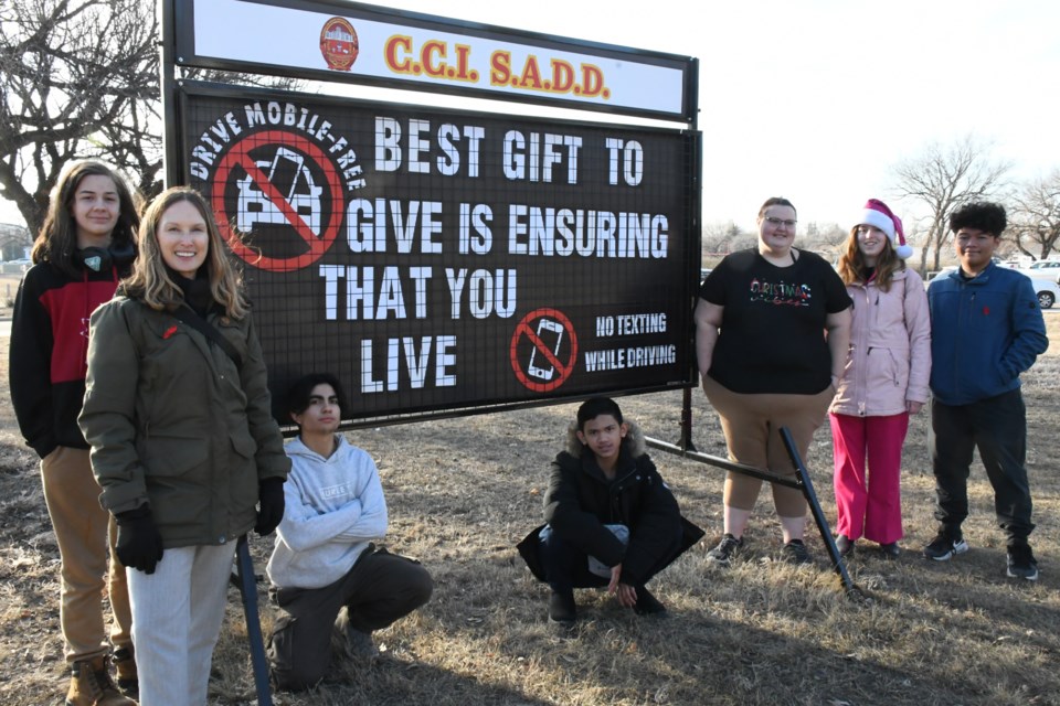 Members of Central Collegiate's Students Against Distracted Driving chapter pose with a new sign they purchased and plan to use to communicate with the community. Photo by Jason G. Antonio