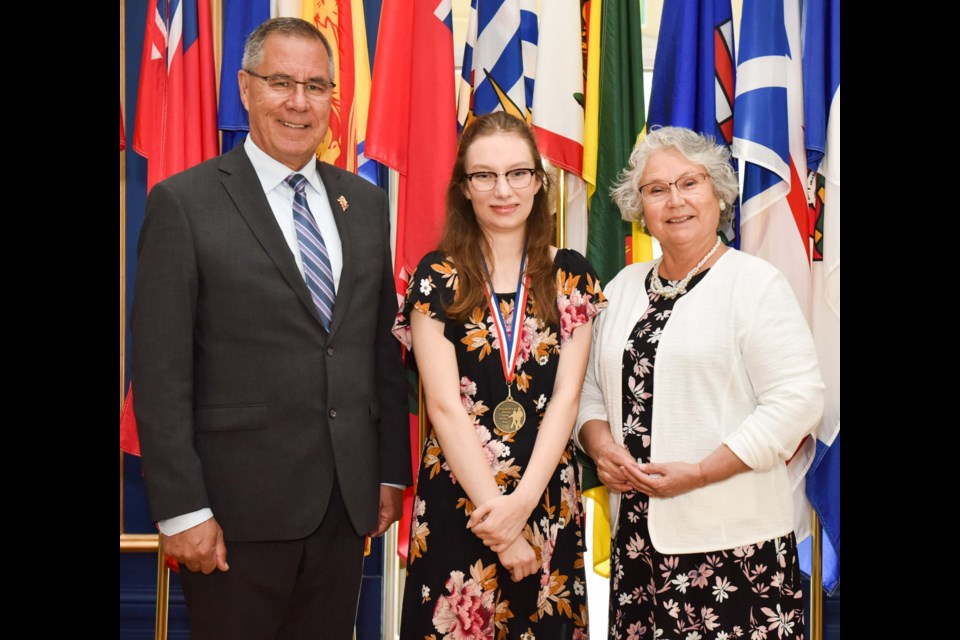 Central Collegiate student Jordyn Montgomery (middle) receives the Junior Citizen of the Year Award from Lt.-Gov. Russ Mirasty and his wife Donna Mirasty. Photo courtesy Saskatchewan Weekly Newspaper Association