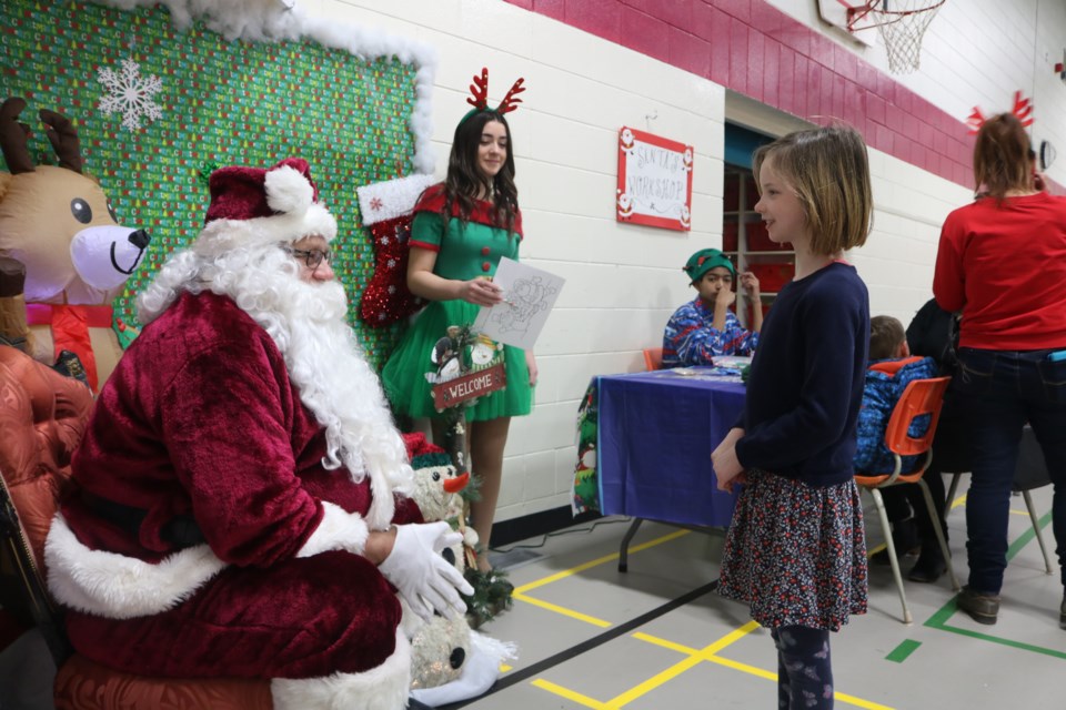 Velia-Ann MacNevin has a chat with Santa Claus at the Sacred Heart School Community Council’s Christmas craft and trade show on Saturday. Photo by Shawn Slaght