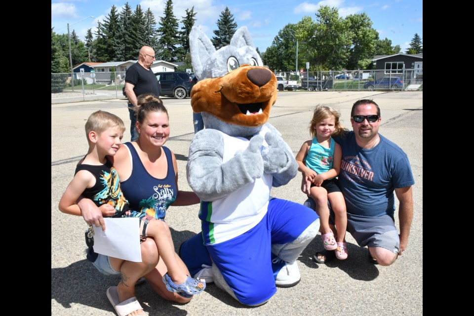 Koda the Coyote from Coteau Hills Elementary School hangs out with families. 