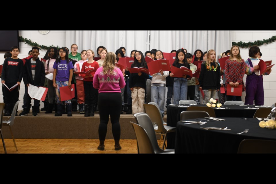 St. Agnes School's choir sings several Christmas tunes as luncheon guests slowly arrive. Photo by Jason G. Antonio